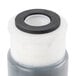A close up of a 3M plastic and rubber water filtration cartridge.