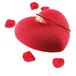 A red heart-shaped cake with strawberries on top in a Silikomart AMORE baking mold.
