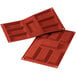 A close-up of a red Silikomart silicone baking mold with 7 Financier cavities.