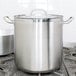 A Vollrath stainless steel stock pot on a stove.