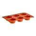 A flexible orange silicone baking mold with six medium-sized muffin compartments.