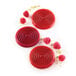 Red round desserts with raspberries in a Silikomart Tourbillon mold.