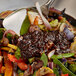 A bowl of food with Lee Kum Kee Black Bean Garlic Sauce on a table.