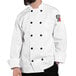 A man wearing a white Uncommon Chef long sleeve chef coat.