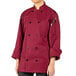 A person wearing a Uncommon Chef maroon long sleeve chef coat.