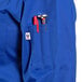 A royal blue Uncommon Chef long sleeve chef coat with a red pen in the pen holder.
