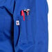 A royal blue long sleeve chef coat with a pen holder.