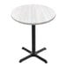 A white round Holland Bar Stool EnduroTop table with a cross base.