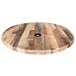 A wooden round table top with a hole in the center.