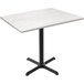 A white Holland Bar Stool EnduroTop table with a black cross base.