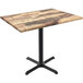 A Holland Bar Stool EnduroTop table with a rustic wood top and black cross base.