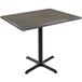 A Holland Bar Stool EnduroTop table with a charcoal wood laminate top and black cross base.