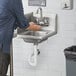 a person washing their hands under a running water faucet