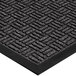 A close-up of a black rubber Lavex parquet entrance mat with a pattern.