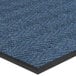 A close up of a blue Lavex Chevron Rib entrance mat with a black border.