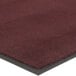 A close-up of a burgundy Lavex Olefin entrance carpet with a black border.