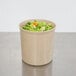 A beige Cambro crock filled with broccoli and carrots.