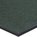 A close up of a green Lavex carpet mat with black trim.