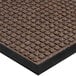 A white background with a close-up of a brown Lavex Waffle entrance mat with a black border.