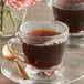 A close-up of a glass cup of Caribou Coffee.