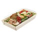 A Solia laminated wooden punnet with a clear plastic lid holding a salad and meat.