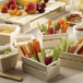 A table with small wooden boxes filled with vegetables.