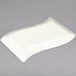 A white rectangular object with a curved edge.