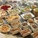 A table with food in Solia rectangular wooden punnets with baking paper.