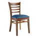 A Lancaster Table & Seating wooden ladder back chair with a navy vinyl seat.
