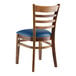 A Lancaster Table & Seating wooden ladder back chair with a navy vinyl seat.