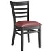 A Lancaster Table & Seating black wood ladder back chair with a red vinyl seat.