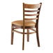 A Lancaster Table & Seating wood ladder back chair with light brown vinyl seat on a white background.