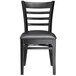 A Lancaster Table & Seating black wood ladder back chair with black vinyl seat