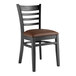 A black Lancaster Table & Seating wood restaurant chair with a dark brown vinyl seat.