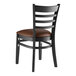 A Lancaster Table & Seating black wood ladder back chair with dark brown vinyl seat.