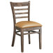 A Lancaster Table & Seating wooden ladder back chair with light brown vinyl seat.