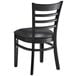 A Lancaster Table & Seating black wood chair with black vinyl cushion.