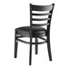 A Lancaster Table & Seating black wood ladder back chair with a black vinyl cushion.