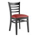 A Lancaster Table & Seating black wood ladder back chair with burgundy vinyl seat.