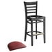 A Lancaster Table & Seating black wood ladder back bar stool with a burgundy vinyl seat.