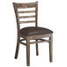 A Lancaster Table & Seating wooden ladder back chair with dark brown vinyl seat.