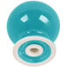 A turquoise ceramic pepper shaker with a white circle on the bottom.