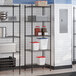 A black epoxy 5-shelf storage rack with 72-inch posts, used for organizing kitchen supplies.