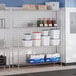 A chrome four-shelf storage rack with adjustable shelves and 72-inch posts.