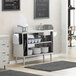 A Regency stainless steel waitress station on a white counter in a professional kitchen.