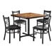 A brown wooden Lancaster Table & Seating butcher block table with four black chairs.