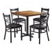 A Lancaster Table & Seating butcher block table with 4 black chairs.