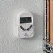 A Comark DTH880 digital thermometer on a wall.