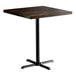 A Lancaster Table & Seating square wood table with an espresso finish and black base plate.