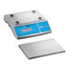 A digital portion control scale with an oversized platform and a blue display panel.